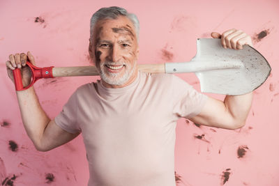 Portrait of happy man with arms raised