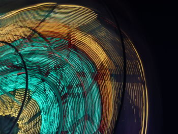 Close-up of illuminated ferris wheel at night