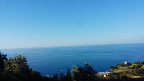 Scenic view of sea against clear blue sky