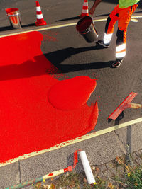 High angle view of red arrow symbol on road in city