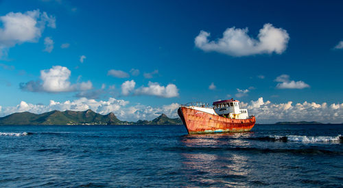 Sailboat in sea against sky