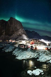 Northern lights over the fishing huts of lofoten islands, norway.