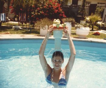 Portrait of smiling young woman swimming in pool