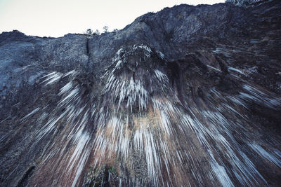 Low angle view of rock formation against sky