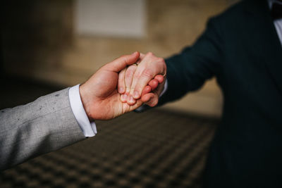 Midsection of businessman holding hands