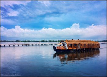 Boat in river against sky