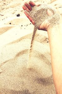 Low section of woman on sand