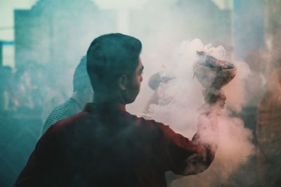 Close-up of man holding dhunuchi at durga puja festival