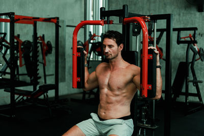 Side view of shirtless young man smoking