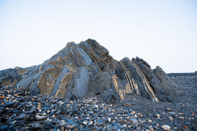 Rock formations on landscape against clear sky