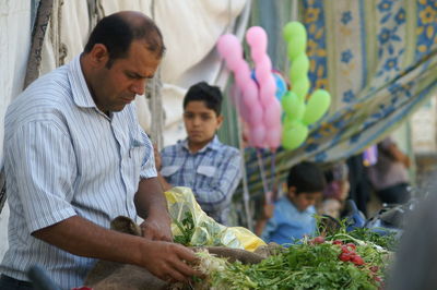 People having food in market