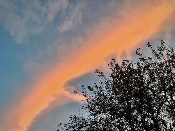 Low angle view of rainbow against sky at sunset