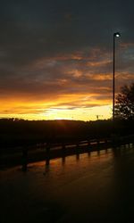 Bridge over river at sunset