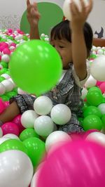 High angle view of boy with ball in balloons