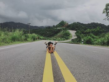 Man standing on road against sky