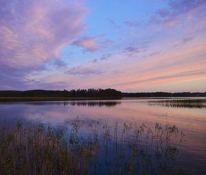 Scenic view of lake against cloudy sky