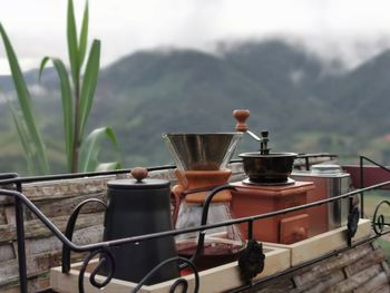 Close-up of drink on table by railing