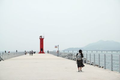 Red lighthouse against clear sky