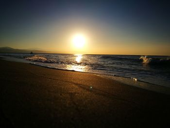 Scenic view of sea against clear sky during sunset