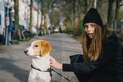 Portrait of woman with dog in winter