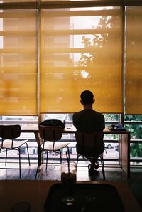 Rear view of man on chair