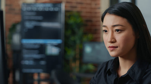 Serious businesswoman sitting at officer