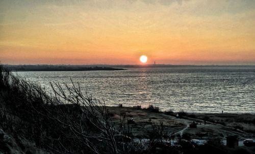 Scenic view of sea against sky at sunset