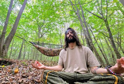 Portrait of woman sitting on tree