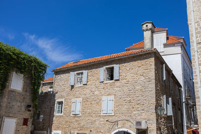 Low angle view of building against clear blue sky