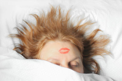 Portrait of woman sleeping on bed