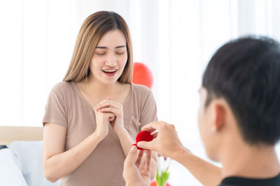 Portrait of a beautiful young woman holding hands