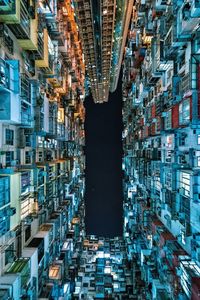 Directly below shot of illuminated buildings in city at night