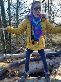 Full length of a smiling girl standing on land