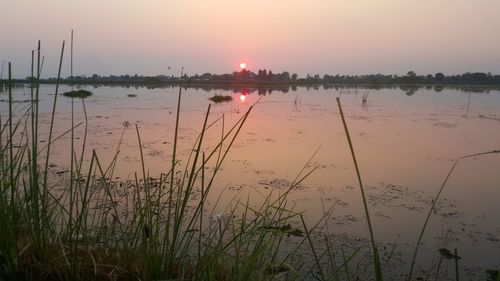 Scenic view of lake against sky during sunset