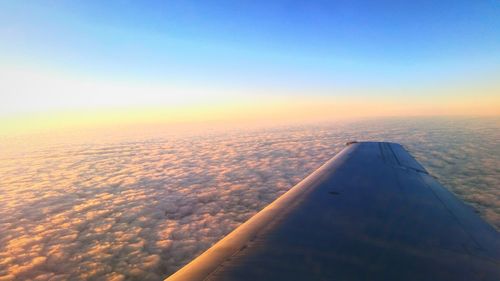 Cropped image of airplane at sunset
