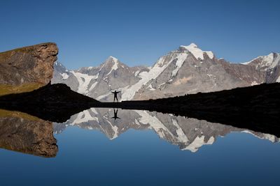 Scenic view of snowcapped mountains against clear blue sky