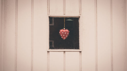 Close-up of heart shape seen through window