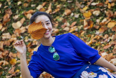 Portrait of smiling young man on field during autumn