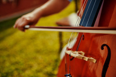 Midsection of woman playing guitar