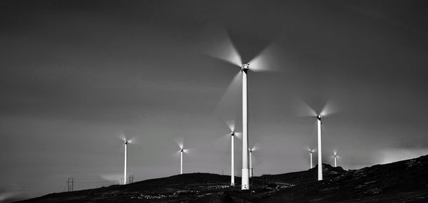 Low angle view of windmill against sky at night