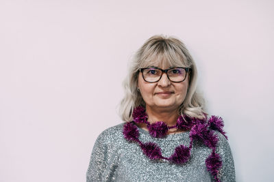 Portrait of woman wearing decoration against wall