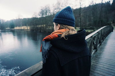 Rear view of man wearing warm clothing in forest