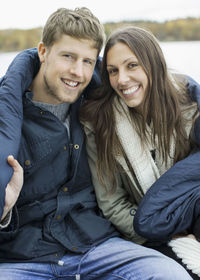 Portrait of happy couple wrapped in blanket