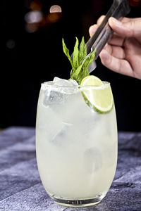 Cocktail in a transparent glass with a starry black background