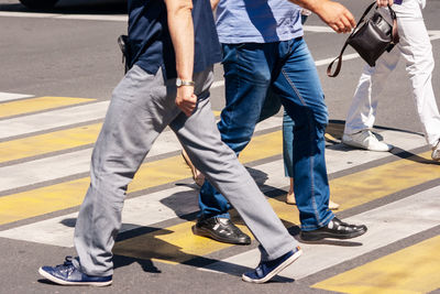 Low section of people standing on road