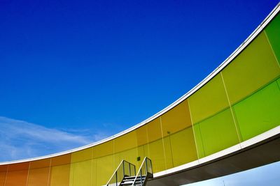 Low angle view of modern building against clear blue sky