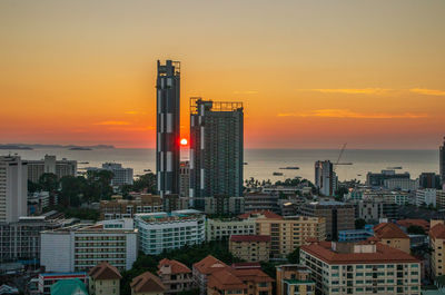 Cityscape against sky during sunset