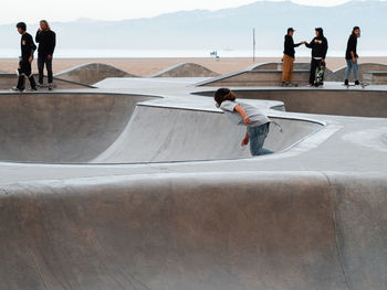 Rear view of people on skateboard