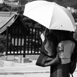 Rear view of man with umbrella