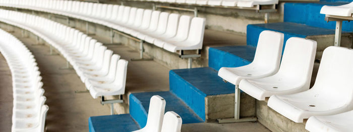 Empty chairs in row in stadium